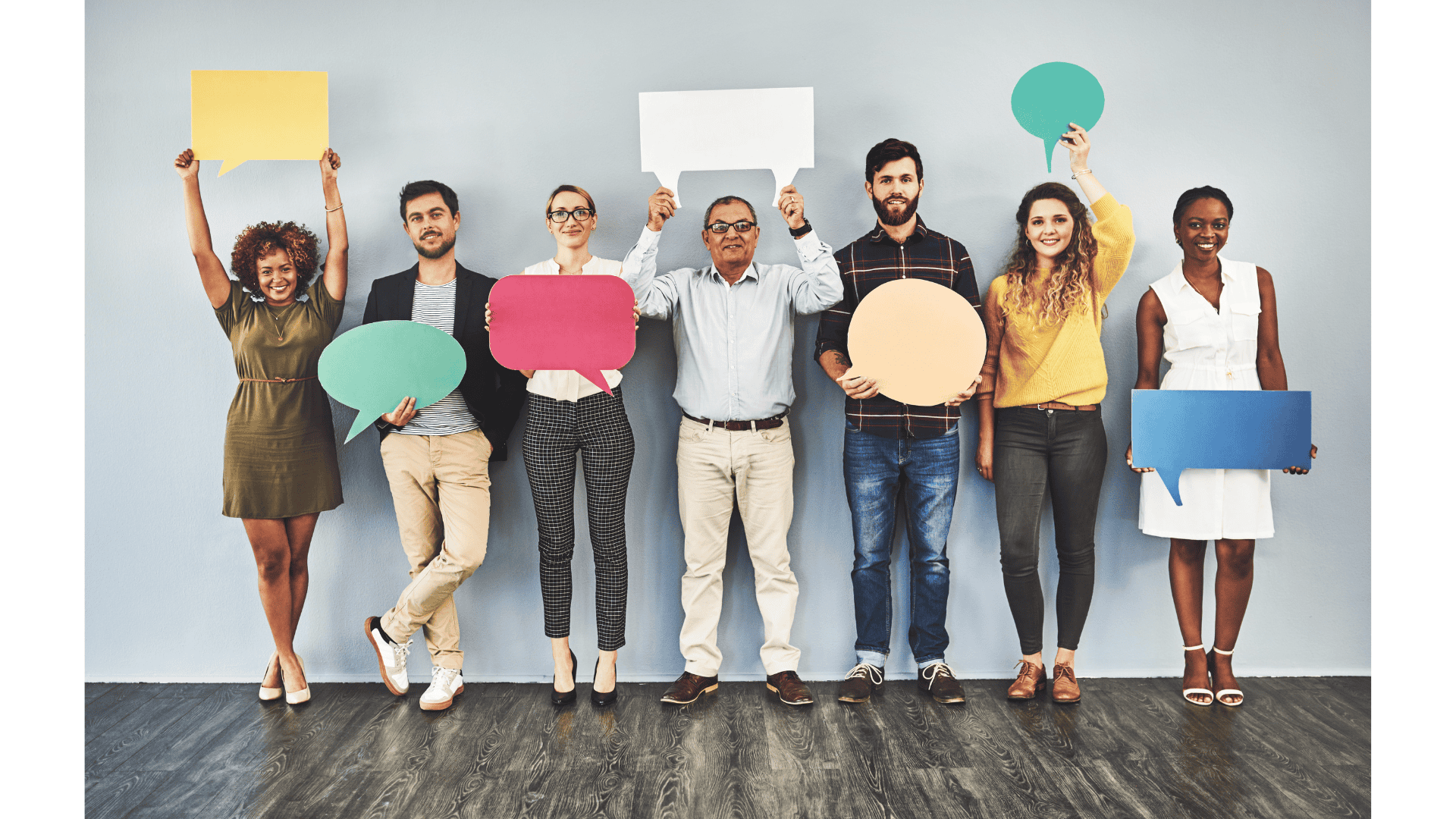 A group of friendly people holding up colorful speech bubbles